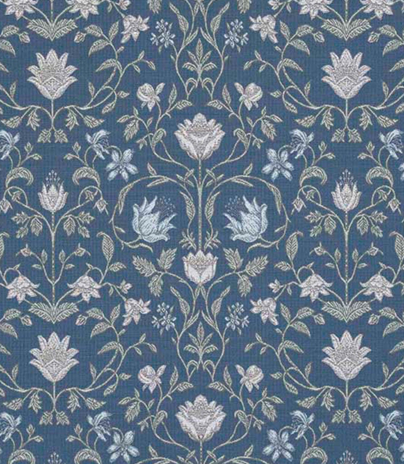 Close-up of a traditional floral fabric showing detailed botanical motifs in soft ivory and pale blue on a deep denim blue background, highlighting the fine linework and woven texture.
