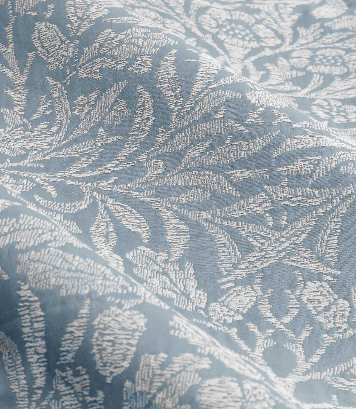 Detailed close-up of Morris & Co Acorn jacquard fabric in Wedgwood blue and off-white, showing the textured weave and traditional botanical pattern.