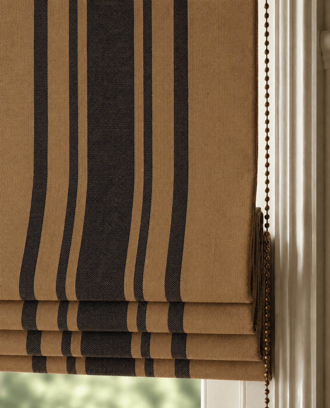 Brown and black striped roman blind against a white wall