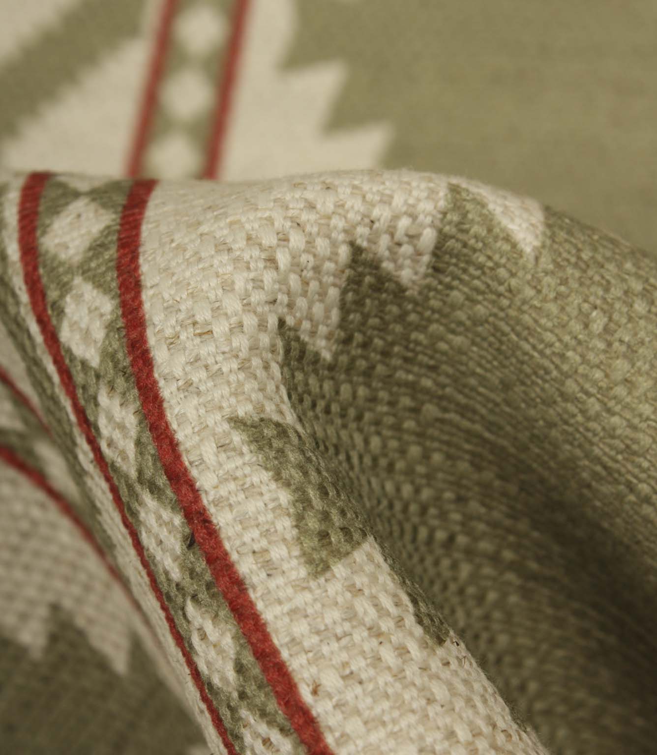 Detailed close-up of sage green patterned fabric revealing the textured weave, natural linen-look finish, and fine red stripe detailing.