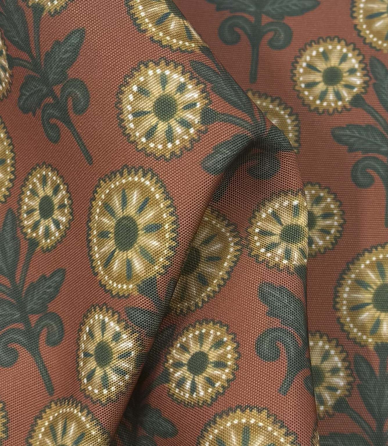 Draped Autumn Sunflower outdoor fabric showing a folk-inspired botanical design in warm rust, olive green, cream, and golden yellow shades.