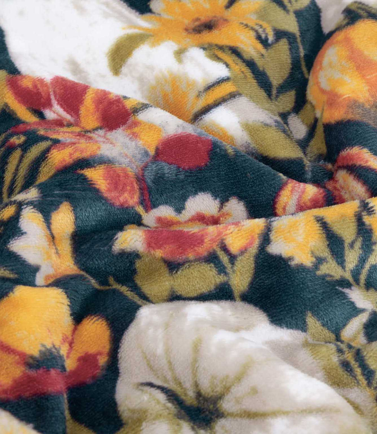 Close-up of the Bootanical Sherpa fleece throw showing the soft plush texture and detailed dark teal, orange, red, cream and green autumn floral and pumpkin pattern.