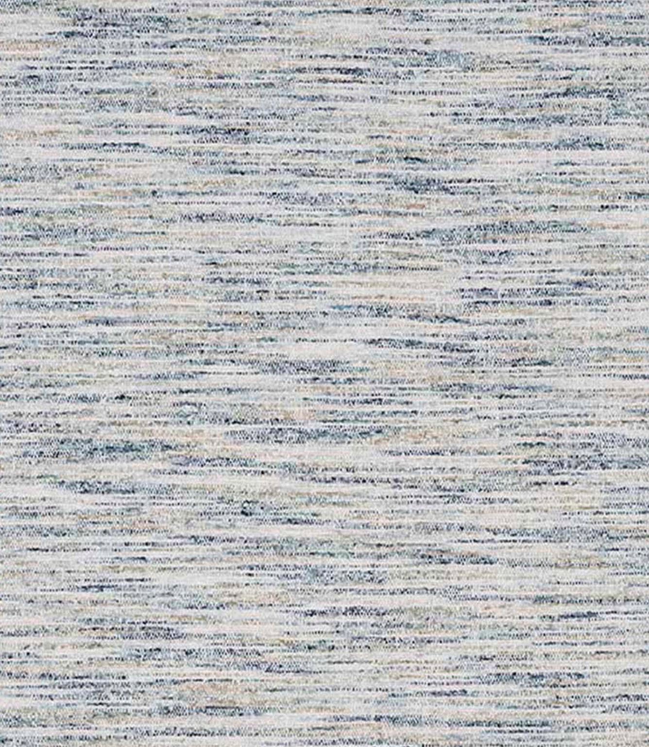 Close-up of woven upholstery fabric in soft neutral tones with subtle blue flecks and a horizontal textured weave.