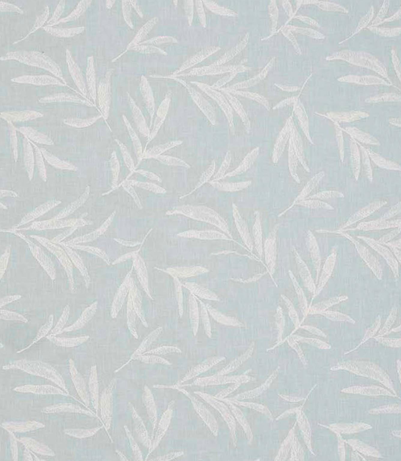 Close-up of embroidered floral upholstery fabric showing delicate leaf motifs in pale blue tones on a softly textured base.