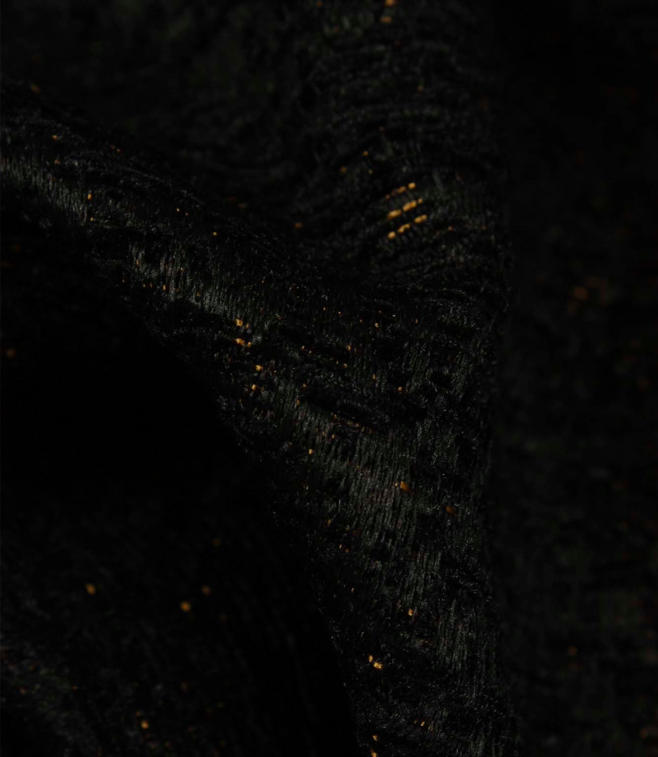 Detailed close-up of Galaxy contemporary fabric in noir black, featuring textured yarns and shimmering metallic flecks.