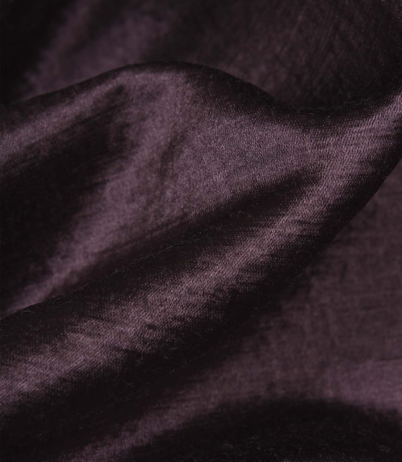 Detailed view of folded Glaze plum faux silk fabric displaying its rich sheen, smooth texture and elegant drape.