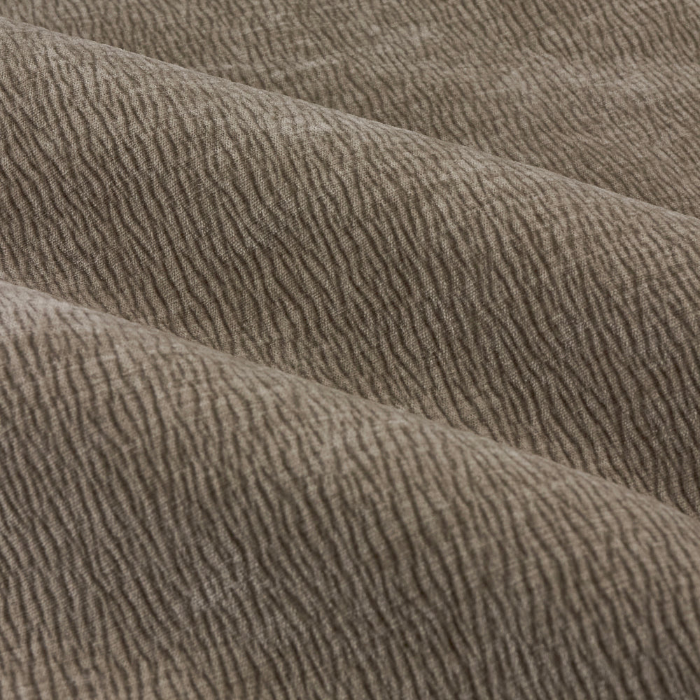 Close-up of greige washed velvet curtain fabric arranged in soft folds, highlighting its plush surface, fine ribbed texture and subtle tonal variation.