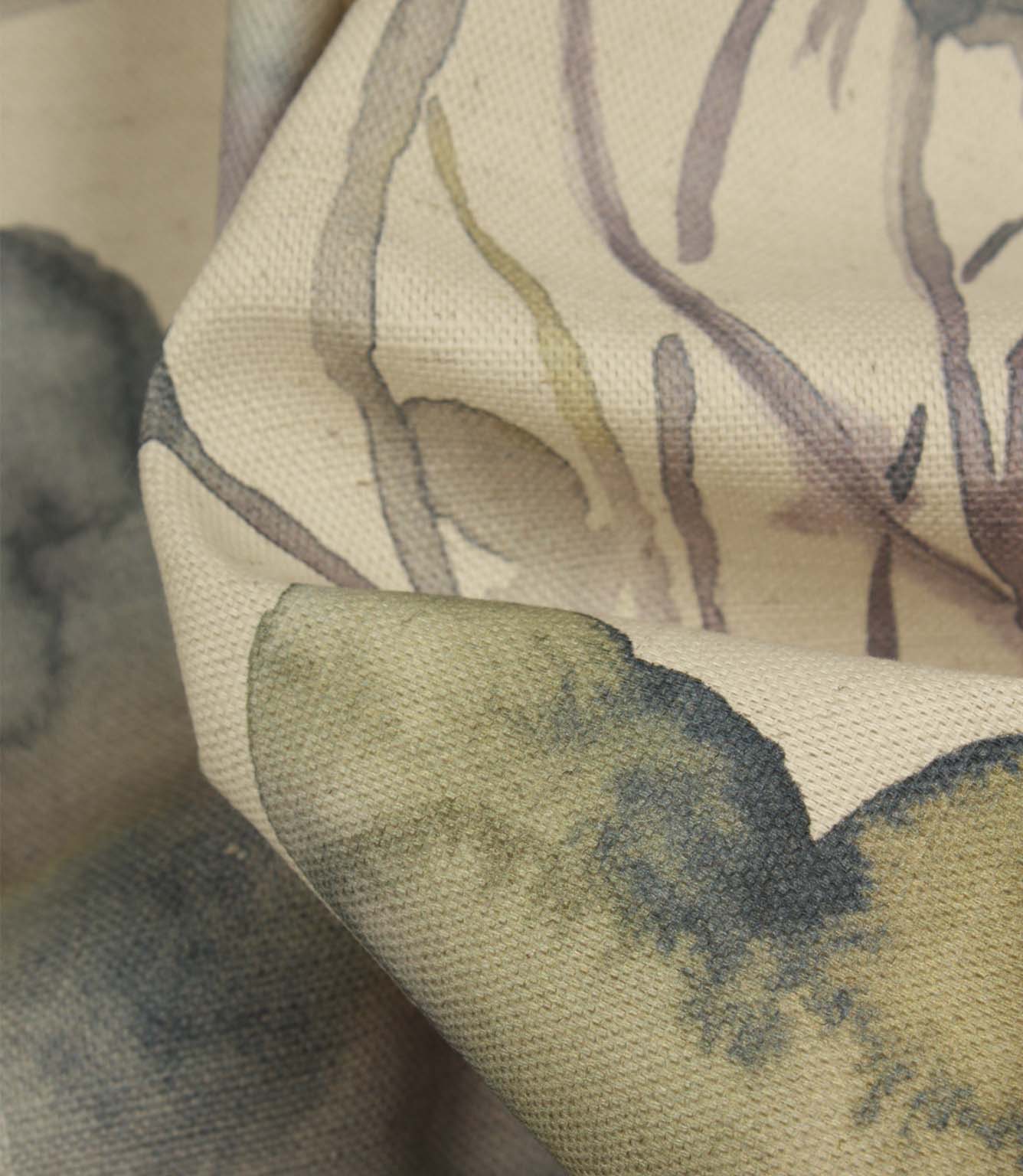 Detailed close-up of Hibberia Crocus cotton fabric showing the textured weave and watercolour floral motifs in soft blue, green and purple tones.