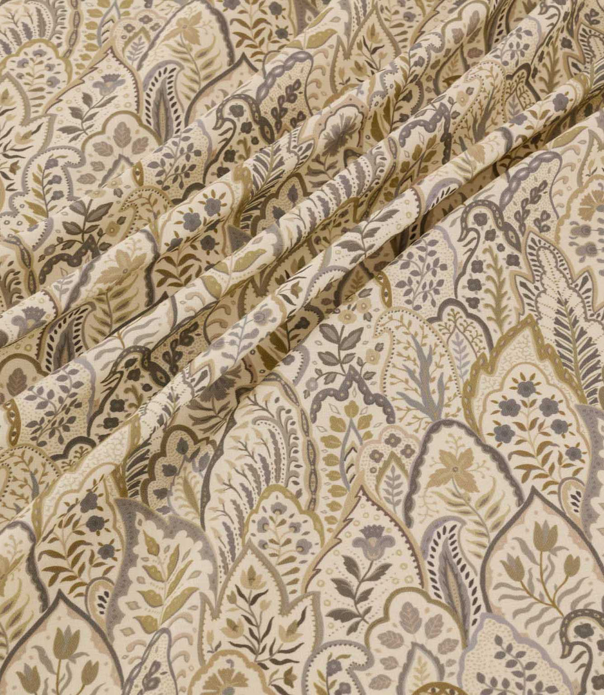 Hitherhill Rockport floral fabric arranged in soft, flowing folds, showcasing its detailed botanical design of stylised flowers, leafy stems and overlapping ornamental shapes in warm beige, taupe, olive and grey tones against an ivory background.