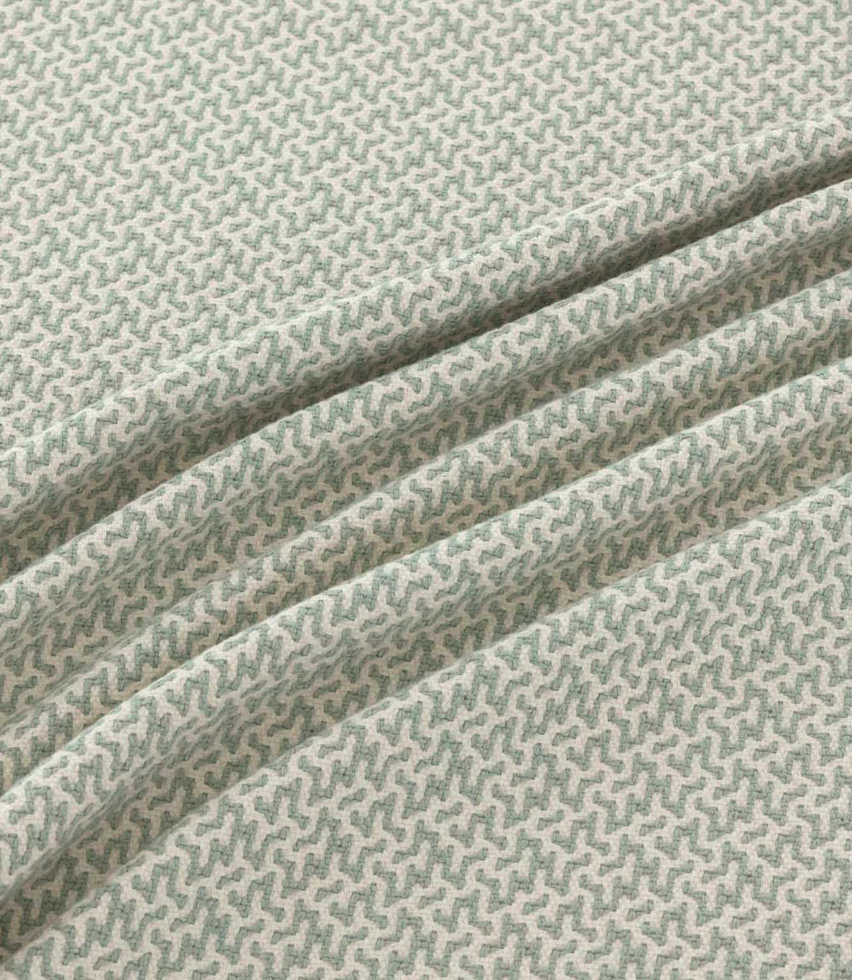 Horton Seafoam pale green and ivory geometric fabric draped in gentle folds, highlighting its small-scale repeating design and woven texture.