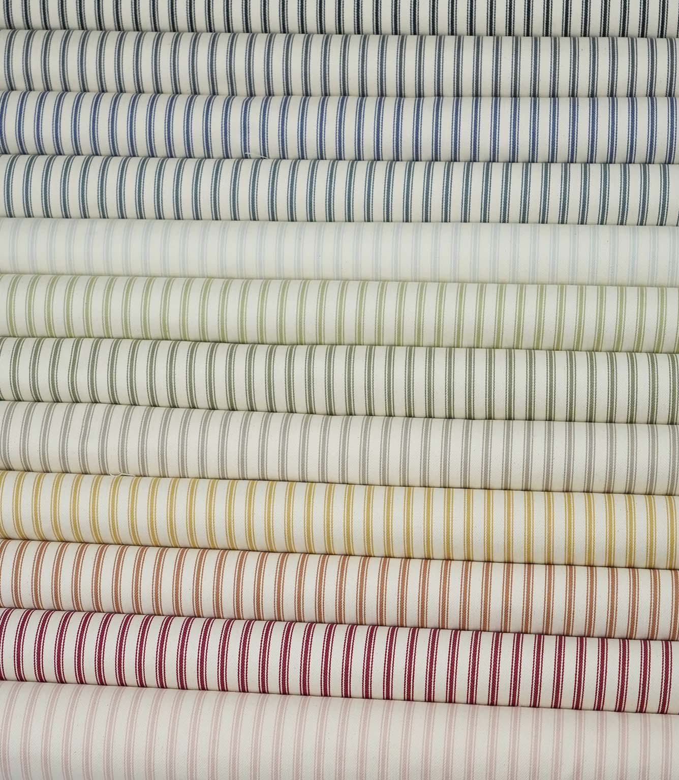 Ticking stripe fabric displayed alongside coordinating colourways from the Just Fabrics collection.