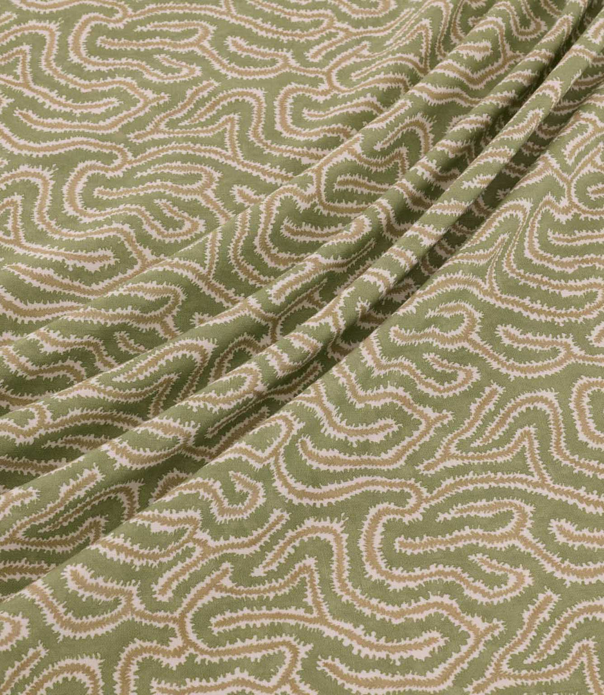 Noyack Kelp fabric arranged in soft, flowing folds, showcasing its muted olive green background and distinctive abstract pattern of winding cream and beige lines, with finely textured edges and a repeating organic design.