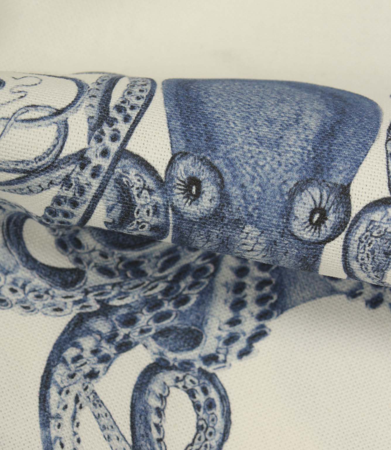 Detailed close-up of octopus printed fabric highlighting intricate tentacle patterns, shading and textured weave finish.