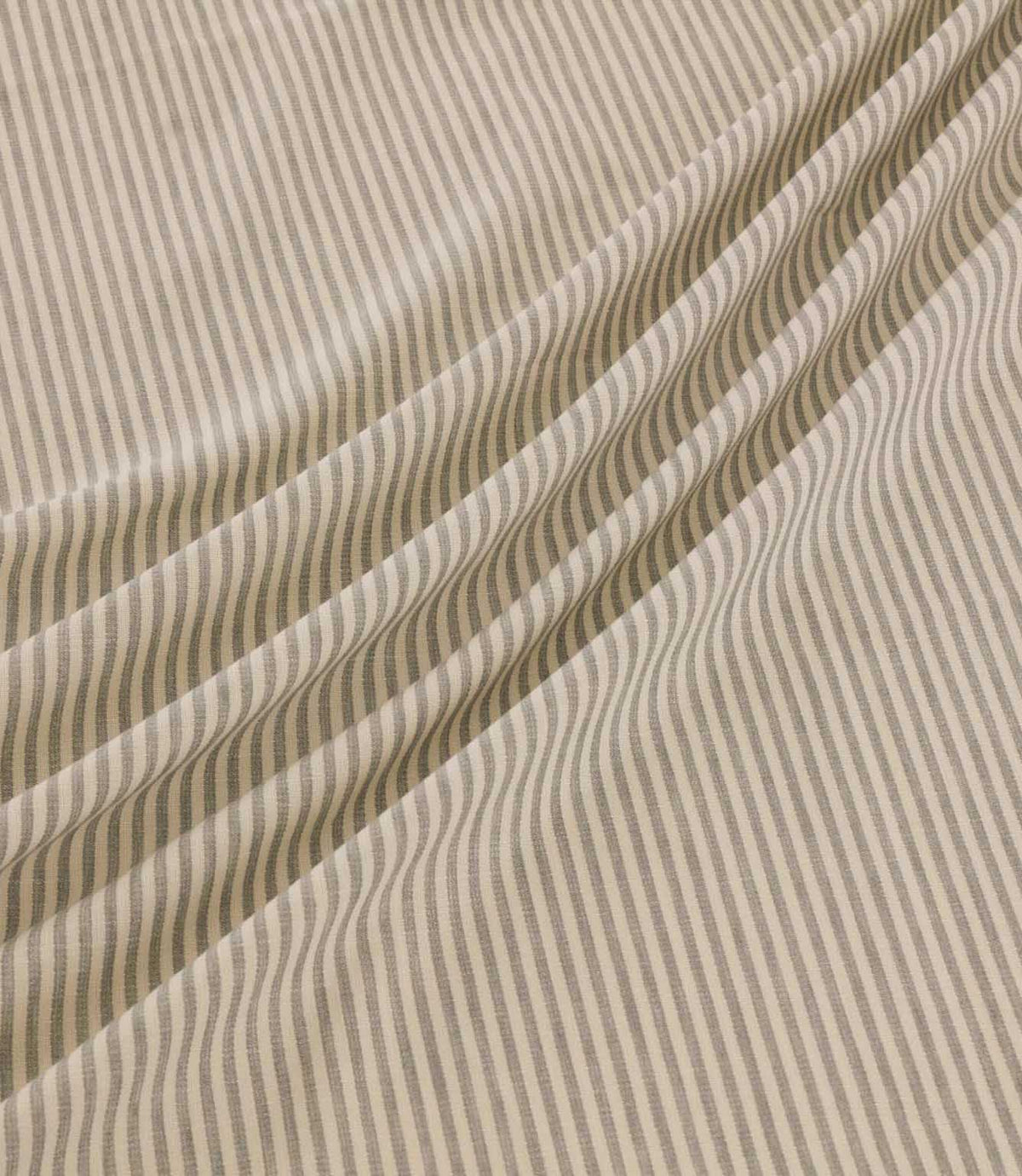 Shoreham Gull striped fabric arranged in soft diagonal folds, showcasing its delicate grey and cream ticking stripe pattern, textured woven surface and natural drape.