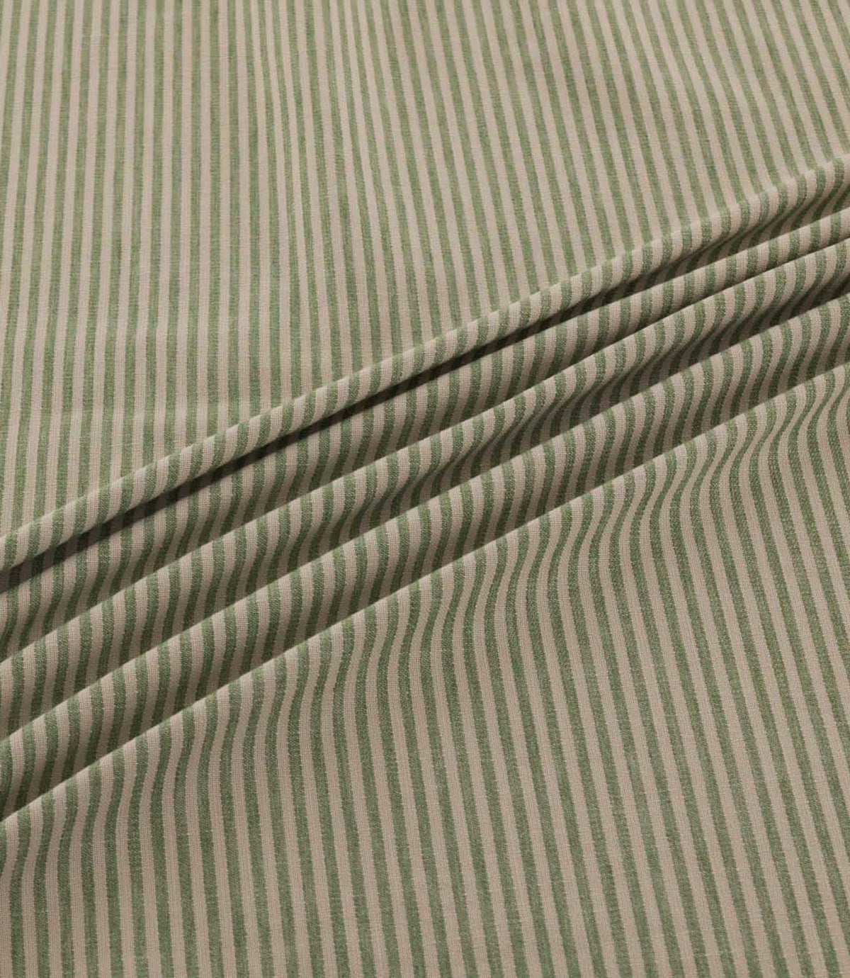 Shoreham Spring fabric arranged in soft, diagonal folds, showcasing its delicate sage green and natural beige vertical stripes, textured woven surface and gentle drape.