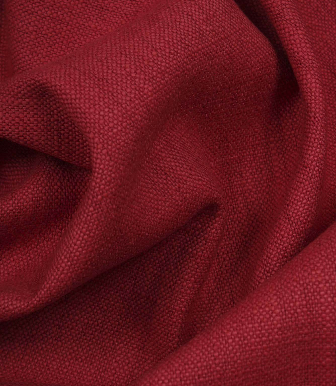 Trento woven fabric in peony draped in soft folds, illustrating its natural texture and suitability for curtains, blinds and cushions.
