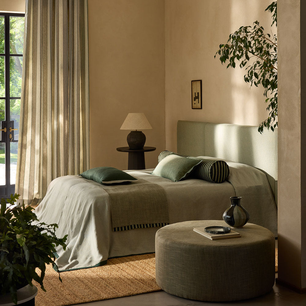 Neutral full-length curtains filtering light in a calm bedroom