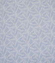 Detailed view of leaf-patterned woven fabric in muted blue and off-white shades, showing a layered foliage design with a gentle, textured finish.