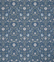 Traditional floral and foliage fabric featuring an intricate symmetrical pattern in soft ivory and pale blue motifs set against a rich denim blue background, with delicate trailing stems and stylised blossoms.