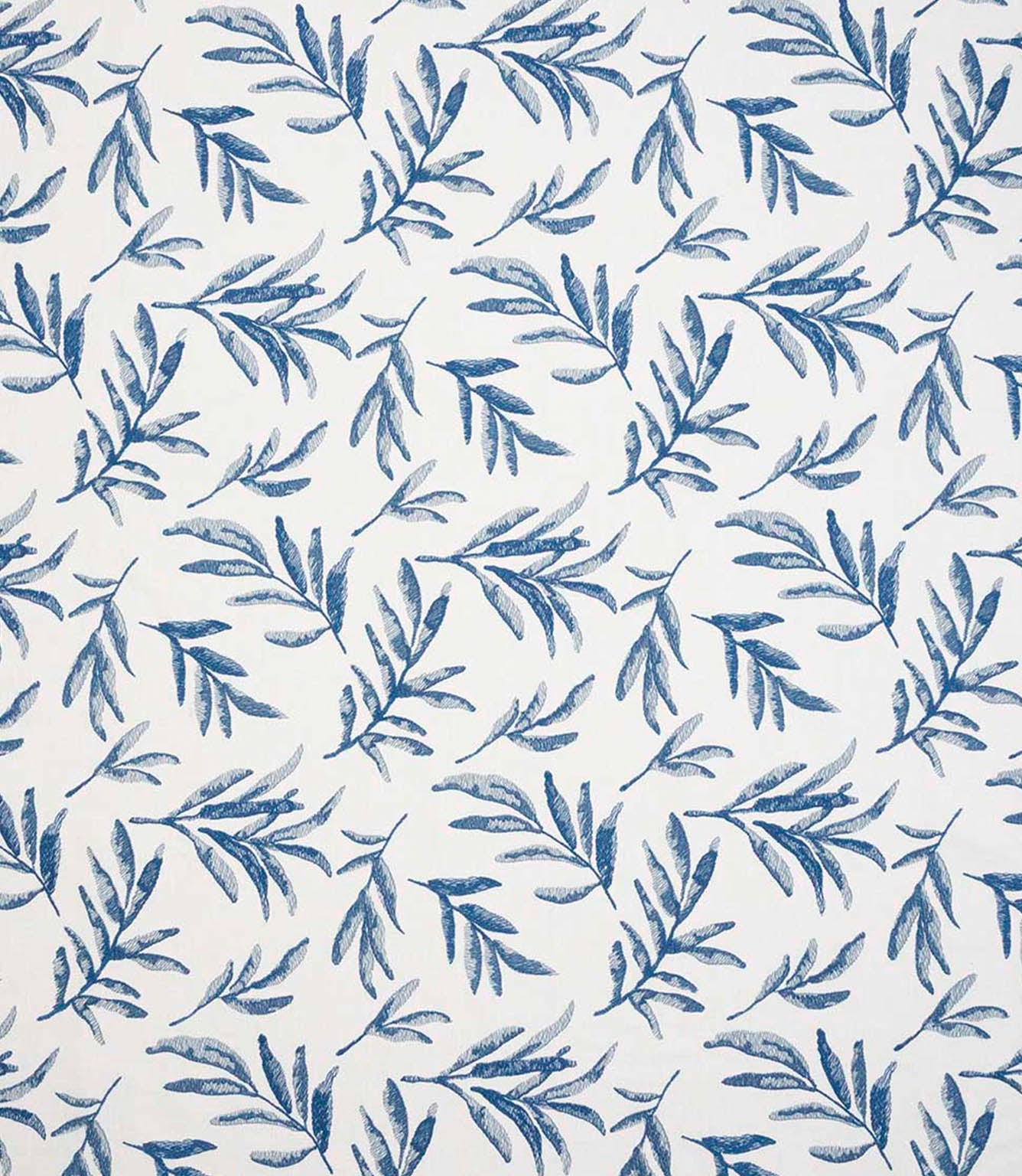 Upholstery fabric with a contemporary embroidered leaf pattern in shades of blue on a soft off-white background.