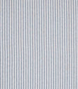 Woven ticking stripe fabric with fine vertical lines in soft blue and neutral tones, set against a light background with a subtle herringbone texture and a calm, tailored appearance.