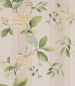 Designer fabric featuring soft green foliage with delicate pale yellow floral clusters on a warm neutral beige background, set against subtle tonal vertical stripes.
