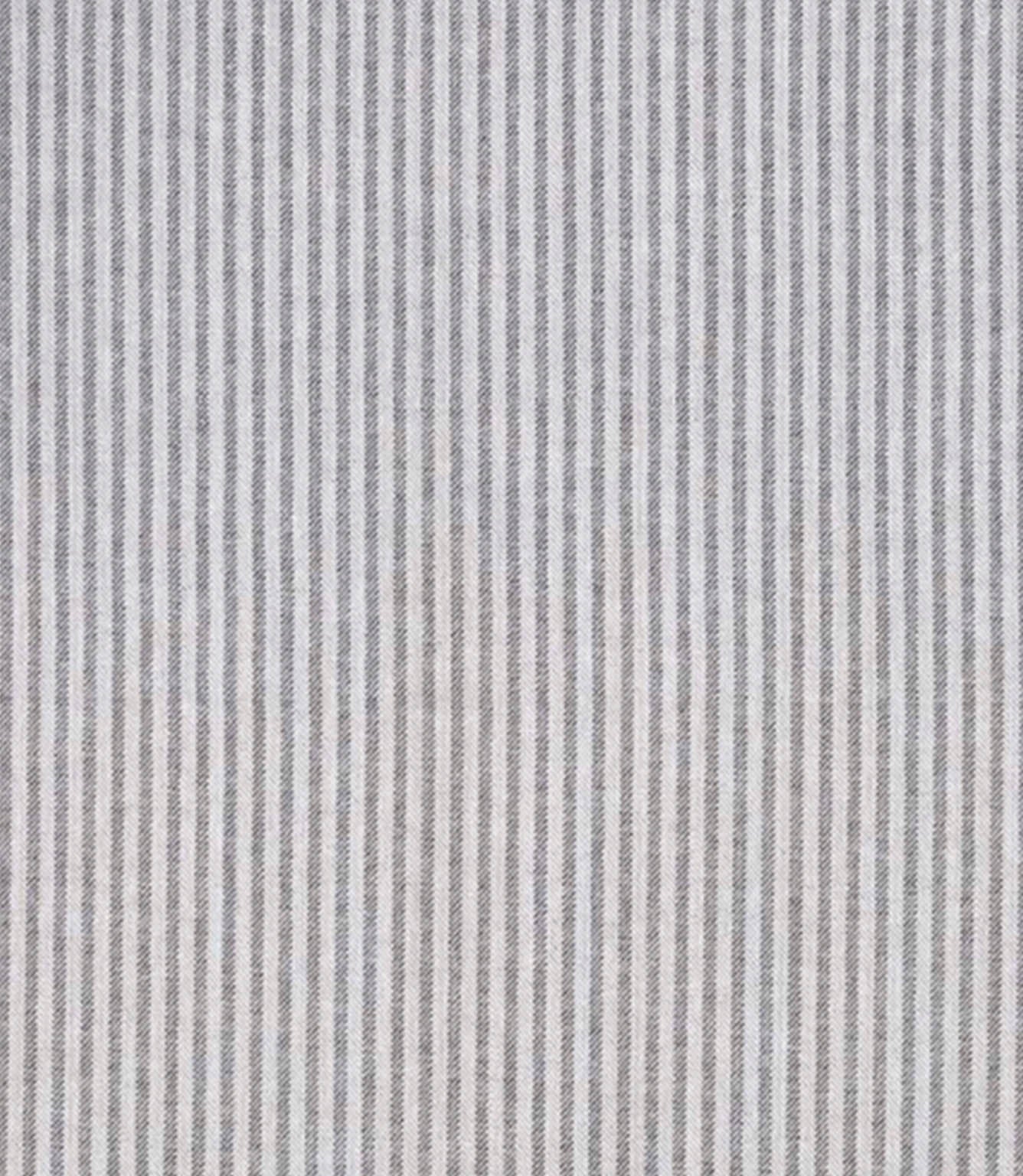 Woven ticking stripe fabric with closely spaced vertical lines in soft grey and charcoal tones on a light background, featuring a refined, understated pattern with gentle texture.