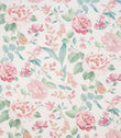 All-over floral designer fabric featuring pink and coral flowers with soft green and teal leaves on a pale ivory ground.