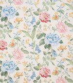 All-over floral designer fabric with trailing stems and blossoms in blue, pink and yellow, complemented by green leaves on an ivory ground.