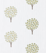 Close-up of embroidered tree motif fabric showing delicate leaf detailing in muted green with small yellow accents and a soft off-white ground, highlighting the fine stitchwork.