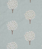 Close-up of embroidered foliage fabric with small stylised tree motifs in soft off-white thread on a muted duck egg blue background, showing fine stitching detail and gentle texture.