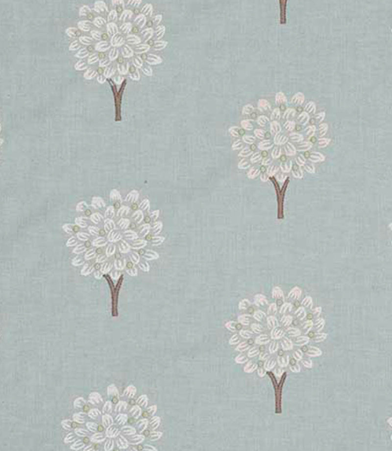 Close-up of embroidered foliage fabric with small stylised tree motifs in soft off-white thread on a muted duck egg blue background, showing fine stitching detail and gentle texture.