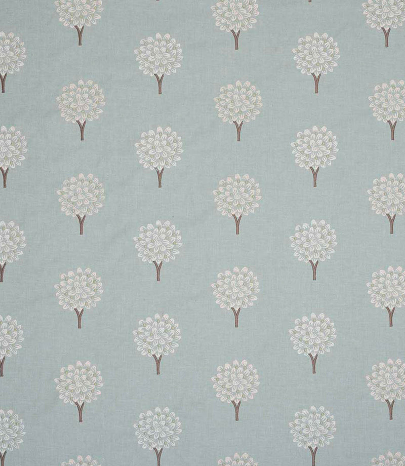 Full repeat view of contemporary embroidered fabric featuring evenly spaced tree motifs in off-white and subtle pastel tones on a soft duck egg blue ground, highlighting the large scale layout and balanced pattern spacing.