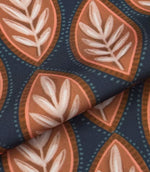 Folded Amber Canopy outdoor upholstery fabric with stylised leaf pattern in warm terracotta, soft pink, and ivory tones against a dark blue base.
