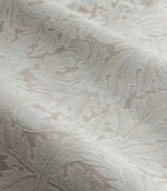 Close-up of Morris & Co Acanthus jacquard fabric in cream and warm beige, showing the raised woven texture and intricate scrolling acanthus leaf pattern.