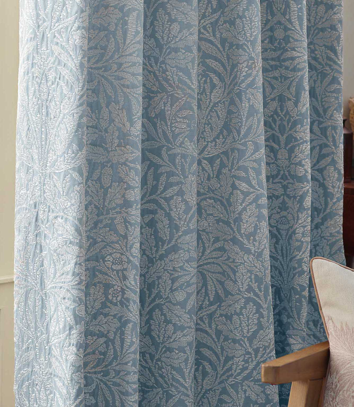 Close-up of Morris & Co Acorn jacquard curtains in Wedgwood blue and off-white, showing the intricate woven acorn, leaf and branch design.