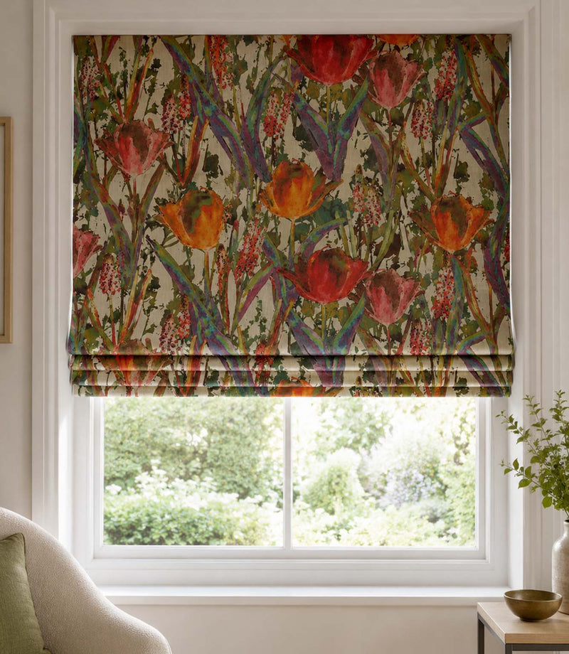 Floral patterned roman blind in a room with a window and decor elements.