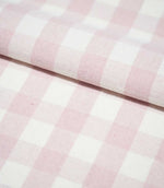 Folded Aldsworth Check Pink fabric displaying its repeating blush pink and white check pattern and subtly textured woven finish.