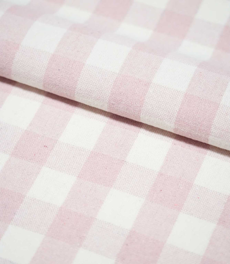 Folded Aldsworth Check Pink fabric displaying its repeating blush pink and white check pattern and subtly textured woven finish.