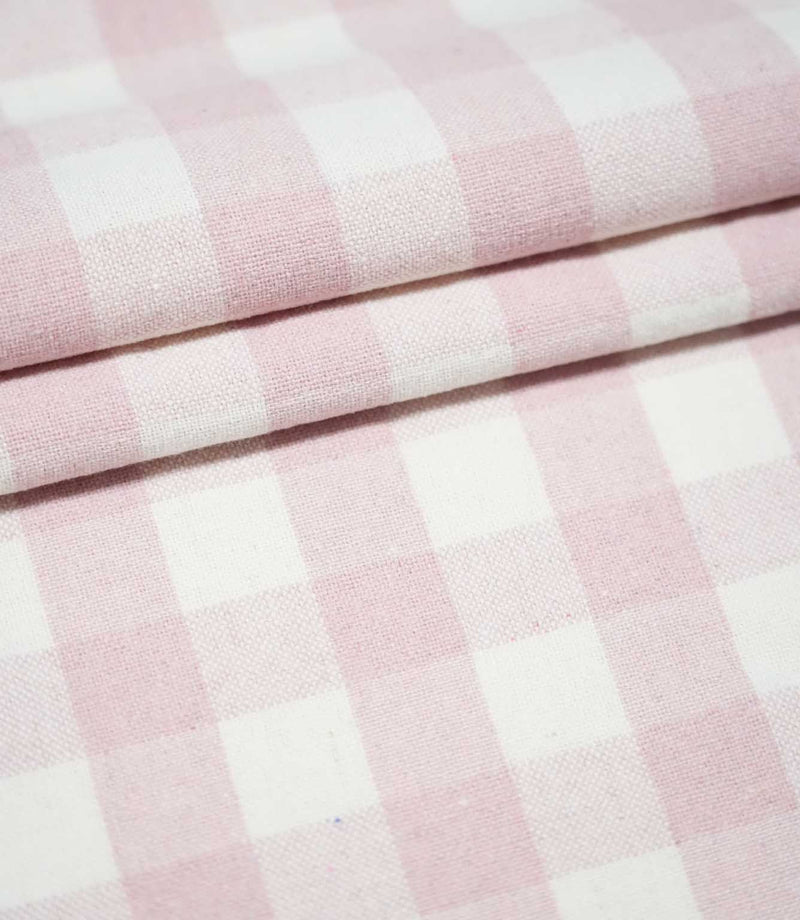 Layers of Aldsworth Check Pink fabric arranged in neat folds, highlighting the classic pink and white checks and woven texture.