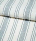 Close-up of folded Aldsworth Stripe Haze fabric highlighting the traditional ticking stripe pattern in muted blue-grey and white.