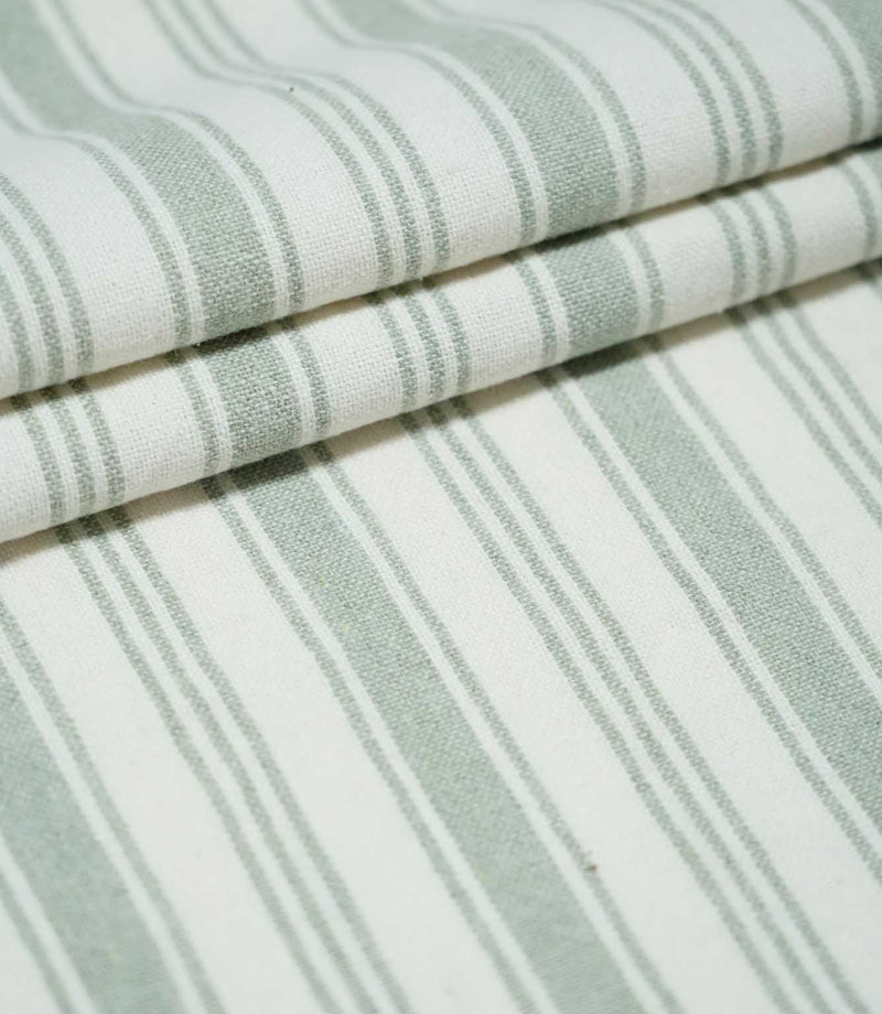 Aldsworth Stripe Mint fabric loosely draped in soft folds, showcasing the traditional green and white striped design and natural woven texture.