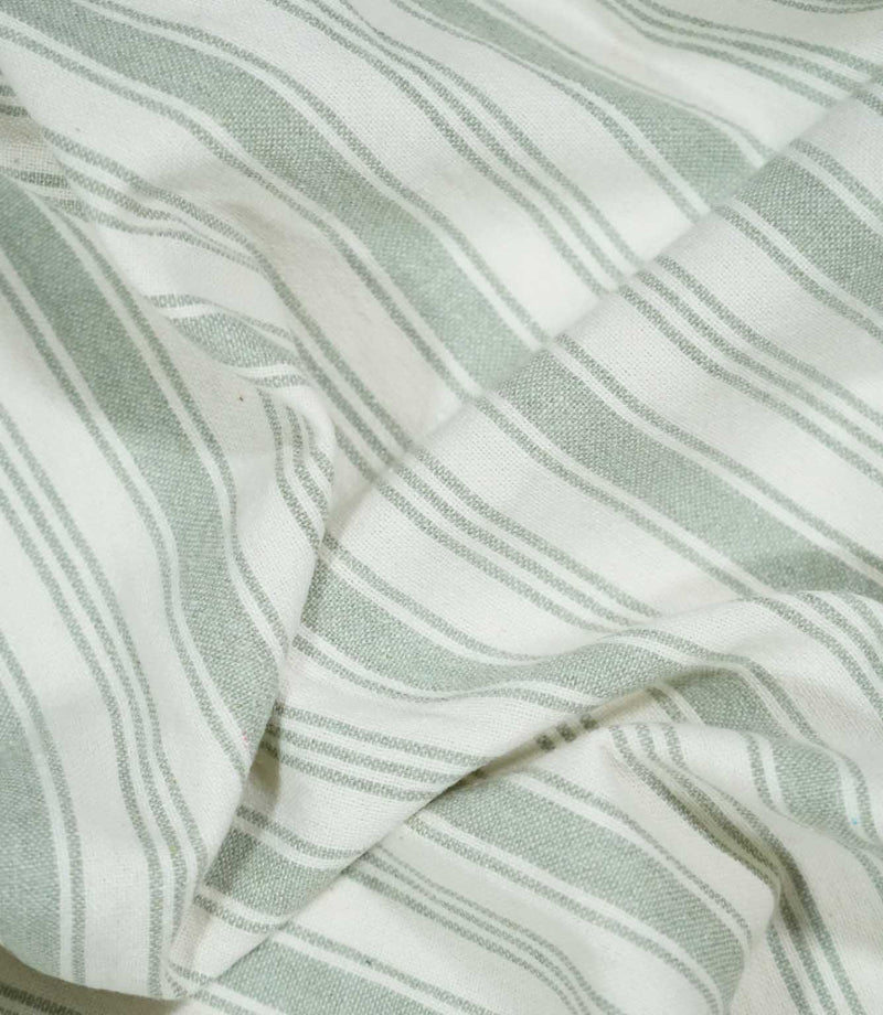 Detailed close-up of Aldsworth Stripe Mint fabric gathered into soft folds, highlighting the subtle mint green ticking stripes and textured surface.