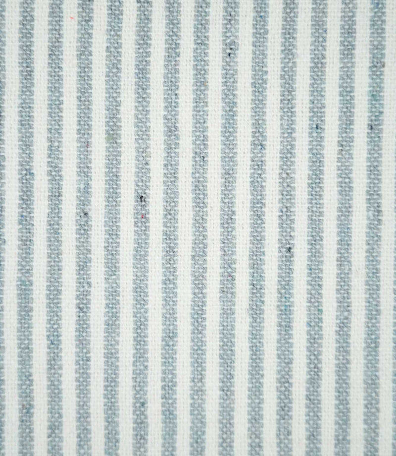 Close-up of Aldsworth Ticking Haze fabric featuring narrow blue-grey and white vertical stripes with a textured woven finish and subtle flecked detailing.