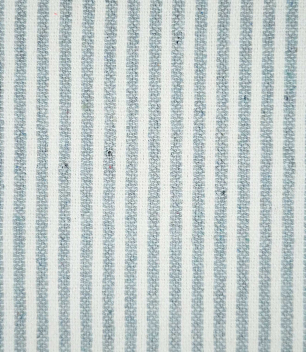 Close-up of Aldsworth Ticking Haze fabric featuring narrow blue-grey and white vertical stripes with a textured woven finish and subtle flecked detailing.