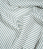 Aldsworth Ticking Haze fabric loosely draped in soft folds, displaying its traditional ticking stripe design and flexible woven texture.