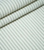 Aldsworth Ticking Mint fabric arranged in layered folds, showcasing its narrow green and white striped pattern and textured woven surface.
