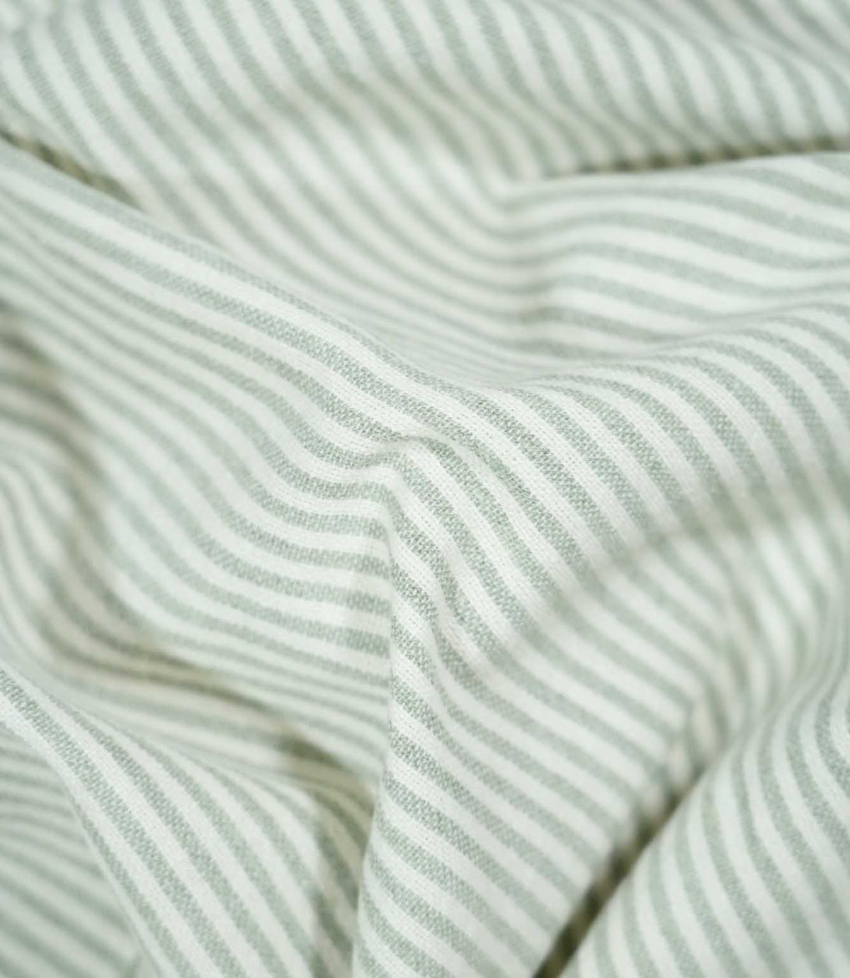 Aldsworth Ticking Mint fabric loosely draped in soft folds, displaying its traditional ticking stripe design and natural-looking woven texture.