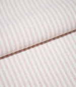 Folded Aldsworth Ticking Pink fabric showing the repeating narrow pink and off-white stripe pattern and detailed woven texture.