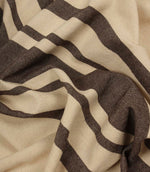 Softly draped brown stripe fabric with wide and narrow stripe detailing on a natural background.